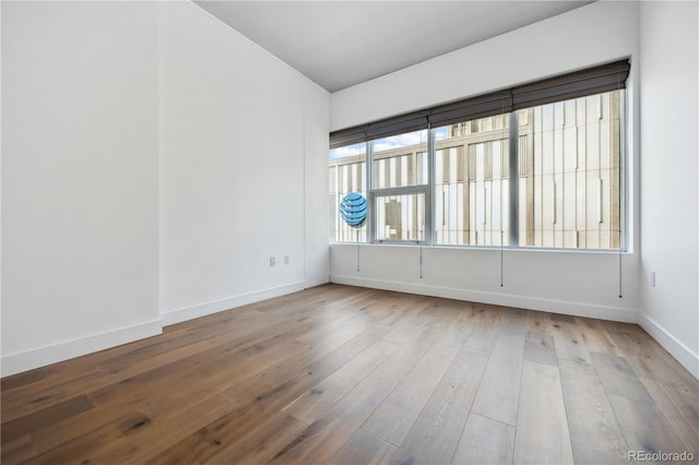 spare room with wood-type flooring