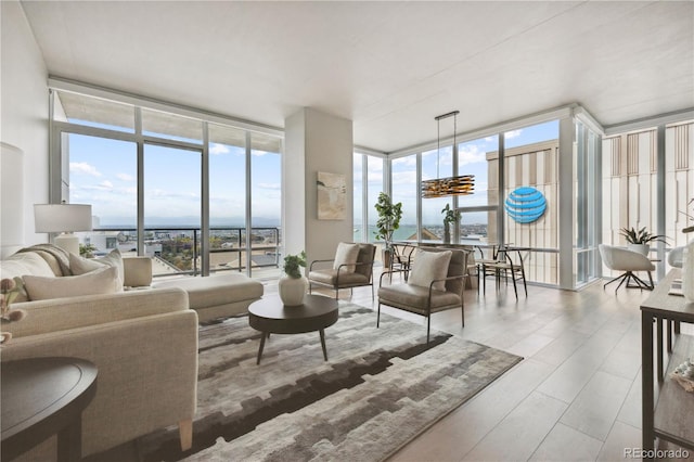 living room featuring floor to ceiling windows and a notable chandelier