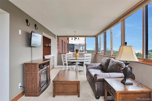 3131 E Alameda Ave Unit 704, Denver, CO 80209 - living area featuring a chandelier, baseboards, and light colored carpet