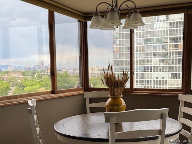 3131 E Alameda Ave Unit 704, Denver, CO 80209 - dining area featuring a view of city and a chandelier