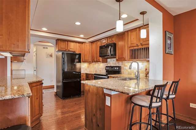 3131 E Alameda Ave Unit 704, Denver, CO 80209 - kitchen featuring black appliances, a sink, a peninsula, light stone countertops, and backsplash