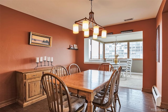 3131 E Alameda Ave Unit 704, Denver, CO 80209 - dining space featuring a baseboard radiator, baseboards, and dark wood finished floors