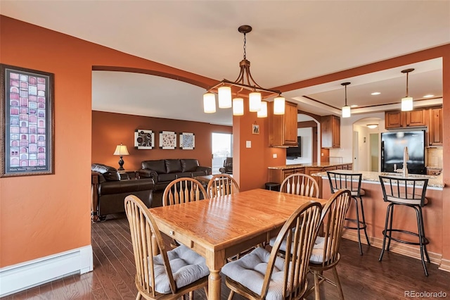 3131 E Alameda Ave Unit 704, Denver, CO 80209 - dining space with a baseboard heating unit, arched walkways, dark wood finished floors, recessed lighting, and baseboards