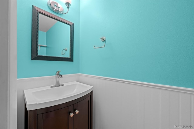 bathroom featuring vanity and a wainscoted wall