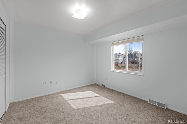 unfurnished bedroom with visible vents, light carpet, and baseboards