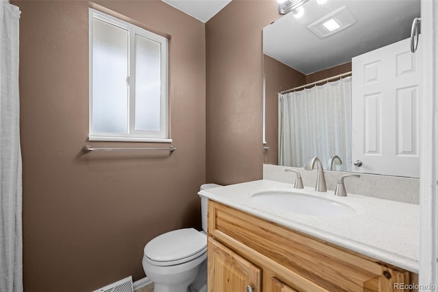 bathroom featuring toilet, vanity, and a shower with curtain