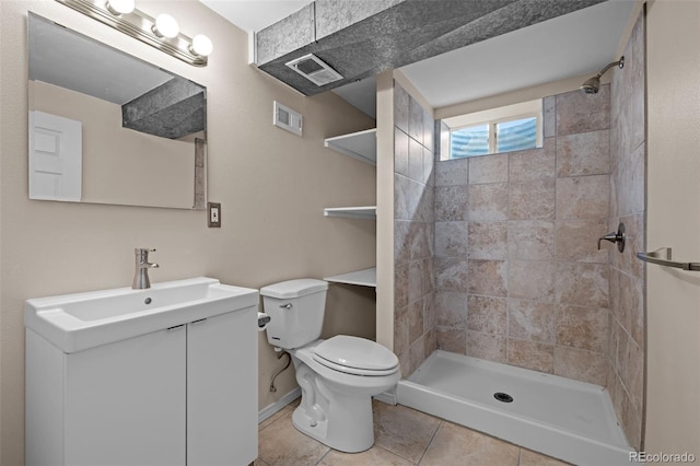 bathroom with a tile shower, visible vents, toilet, and vanity