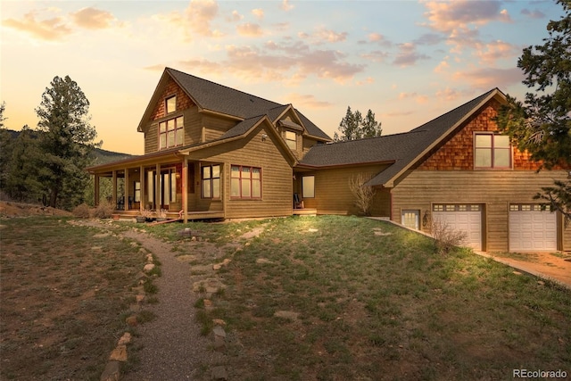 582 Buddy Rd, Bailey, CO 80421 - view of front facade with a porch, a front lawn, an attached garage, and driveway