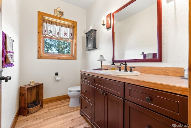 582 Buddy Rd, Bailey, CO 80421 - bathroom featuring vanity, baseboards, toilet, and wood finished floors