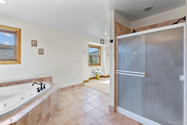 582 Buddy Rd, Bailey, CO 80421 - full bathroom featuring a tub with jets, tile patterned flooring, baseboards, and a stall shower