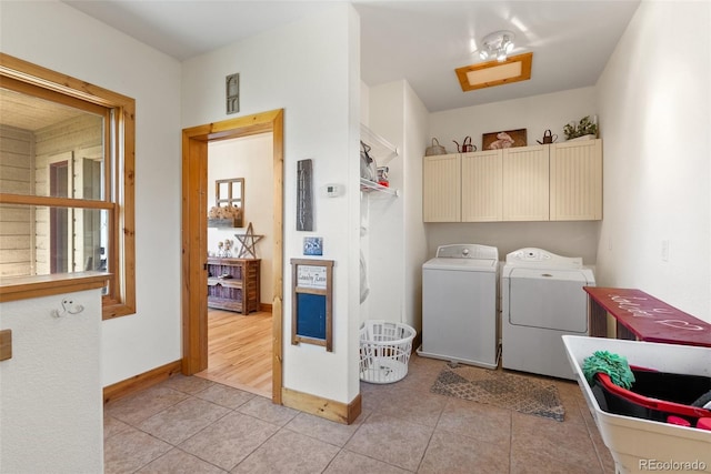 582 Buddy Rd, Bailey, CO 80421 - washroom featuring baseboards, cabinet space, independent washer and dryer, and light tile patterned floors