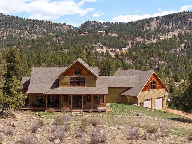 582 Buddy Rd, Bailey, CO 80421 - view of front facade featuring a porch, a view of trees, and a mountain view