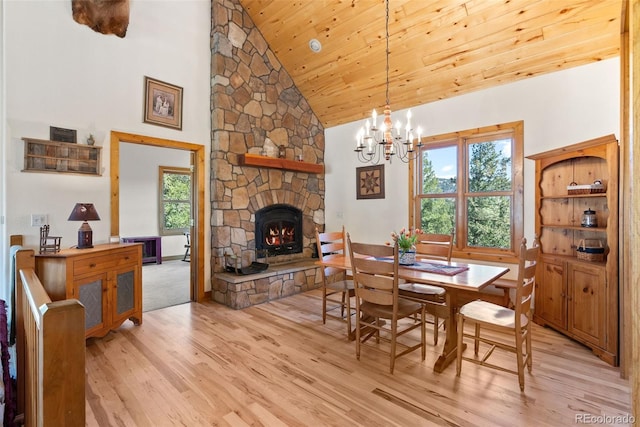 582 Buddy Rd, Bailey, CO 80421 - dining room with an inviting chandelier, a fireplace, light wood-style floors, high vaulted ceiling, and wooden ceiling