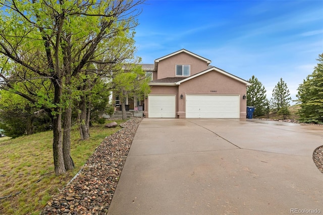 11960 Conestoga Trl, Elbert, CO 80106 - view of front of home with stucco siding, driveway, and a garage
