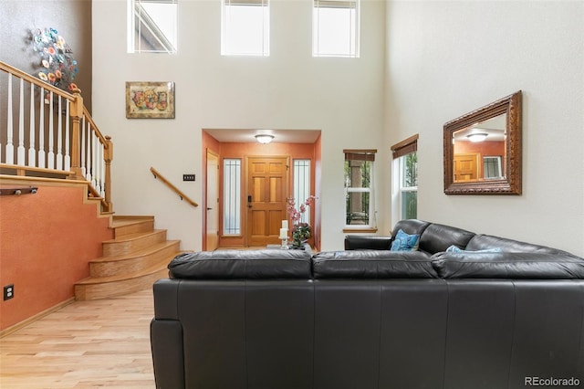 11960 Conestoga Trl, Elbert, CO 80106 - living area with a towering ceiling, wood finished floors, and stairs