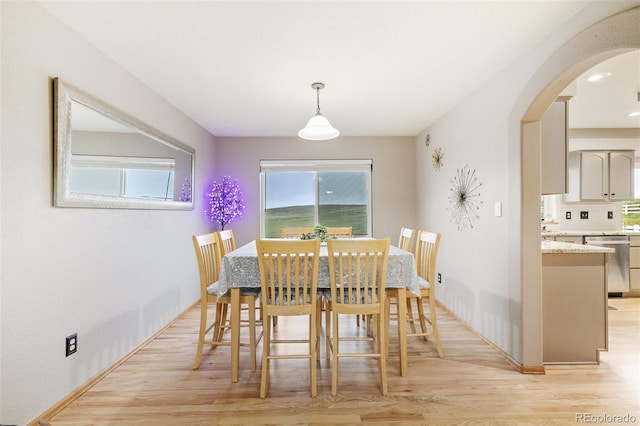 11960 Conestoga Trl, Elbert, CO 80106 - dining space featuring arched walkways, light wood-style flooring, and baseboards