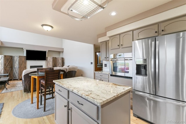 11960 Conestoga Trl, Elbert, CO 80106 - kitchen with stainless steel appliances, gray cabinetry, light wood-style flooring, a center island, and recessed lighting