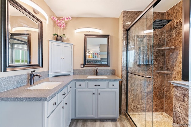 11960 Conestoga Trl, Elbert, CO 80106 - bathroom featuring double vanity, a stall shower, and wood finished floors