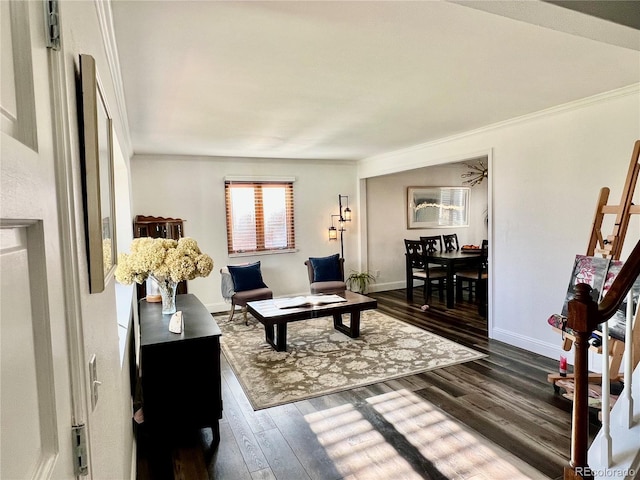 living room with baseboards, ornamental molding, and wood finished floors