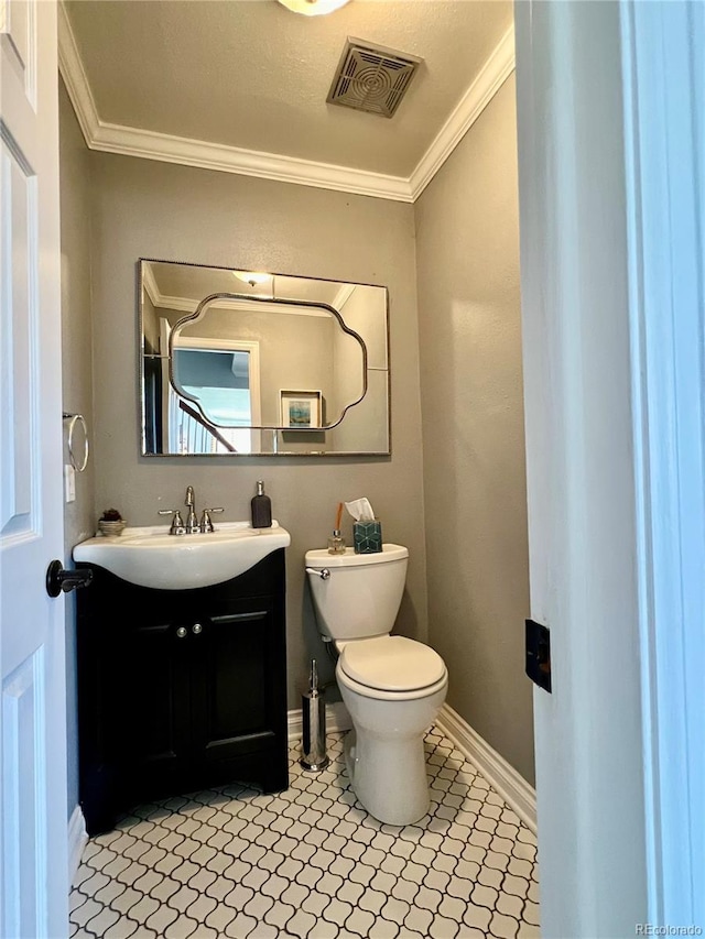 half bathroom featuring crown molding, vanity, toilet, and visible vents