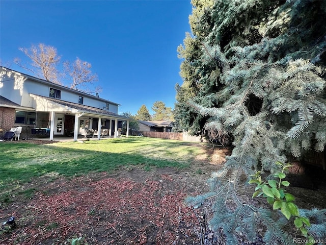 view of yard featuring a patio and fence