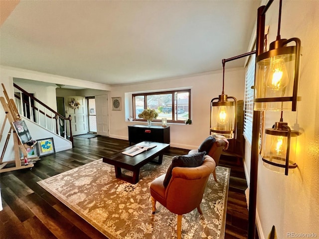 living area with crown molding, baseboards, dark wood-style floors, and stairway