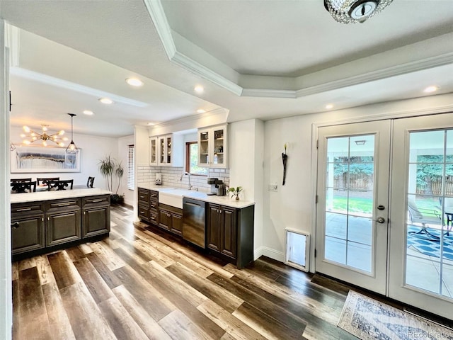 kitchen with light countertops, stainless steel dishwasher, and dark brown cabinets