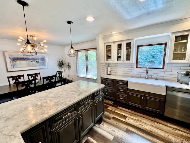 kitchen with crown molding, a sink, dishwasher, and wood finished floors