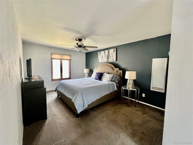 carpeted bedroom with a ceiling fan and baseboards