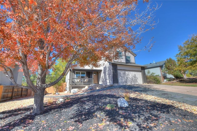 view of front of home featuring covered porch and a garage