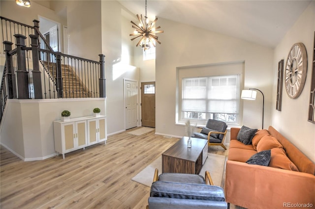 living room featuring light wood-type flooring, high vaulted ceiling, and a notable chandelier