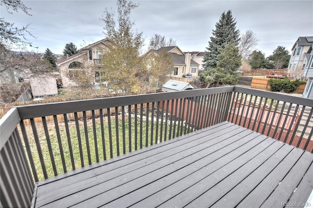 wooden deck with a lawn