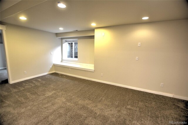 basement featuring dark carpet