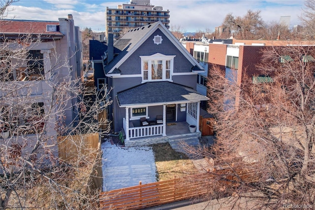 back of property featuring covered porch