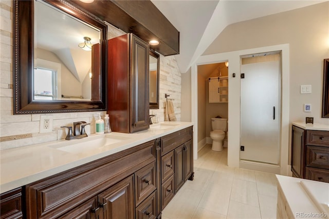 bathroom featuring lofted ceiling, a shower with door, vanity, decorative backsplash, and toilet