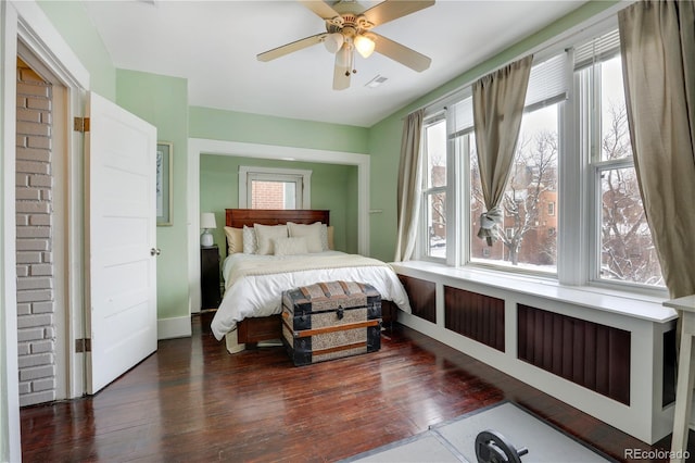 bedroom with ceiling fan and dark hardwood / wood-style flooring