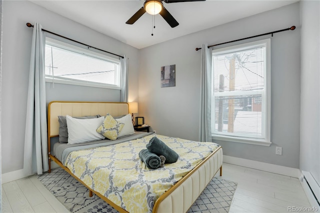 bedroom featuring baseboard heating and ceiling fan