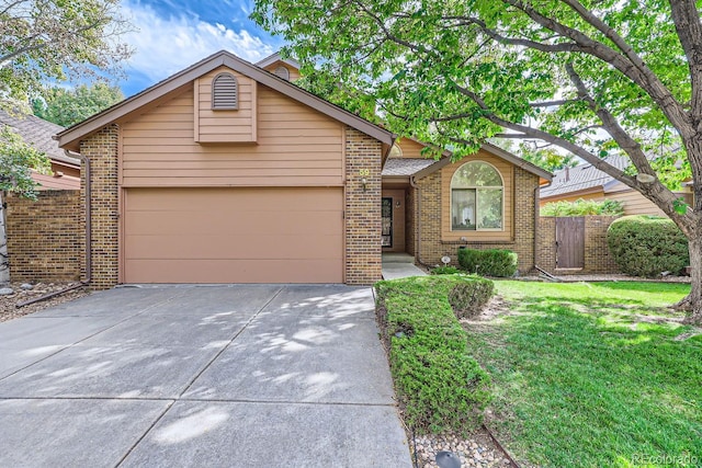 ranch-style house featuring a front lawn and a garage