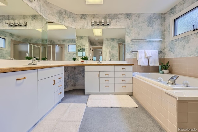 bathroom featuring shower with separate bathtub and vanity