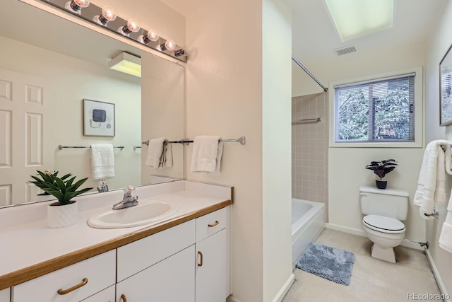 full bathroom with tiled shower / bath, vanity, and toilet