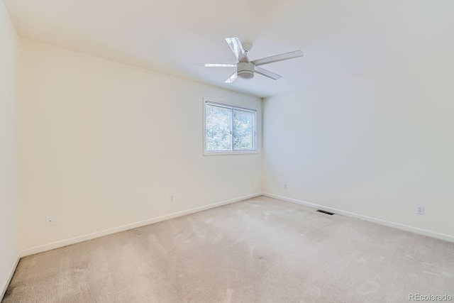 spare room with light carpet and ceiling fan