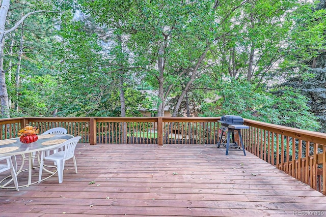 wooden terrace with a grill