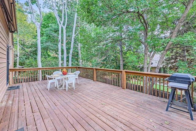 wooden deck featuring a grill