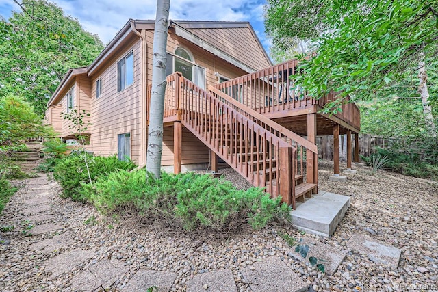 back of property with a wooden deck