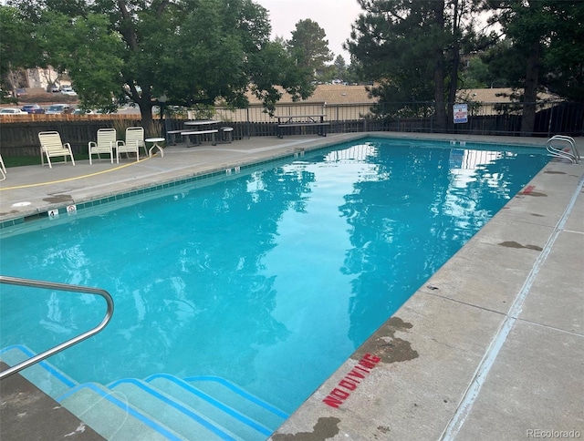 view of swimming pool with a patio