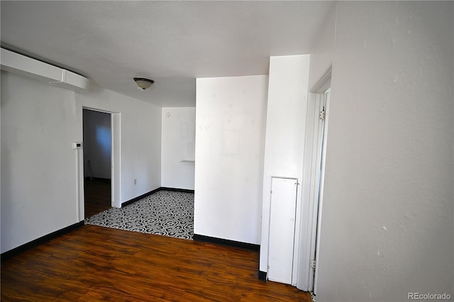 unfurnished room with dark hardwood / wood-style floors