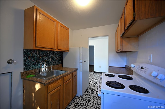 kitchen featuring decorative backsplash, white appliances, and sink