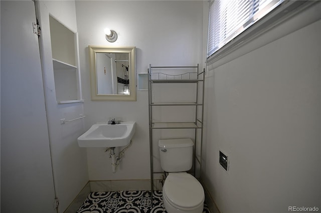 bathroom featuring tile patterned floors, toilet, and sink