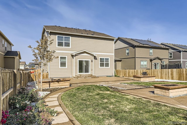 rear view of house with a patio and a lawn