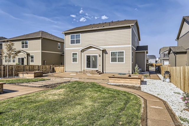 back of house featuring a lawn and a patio area